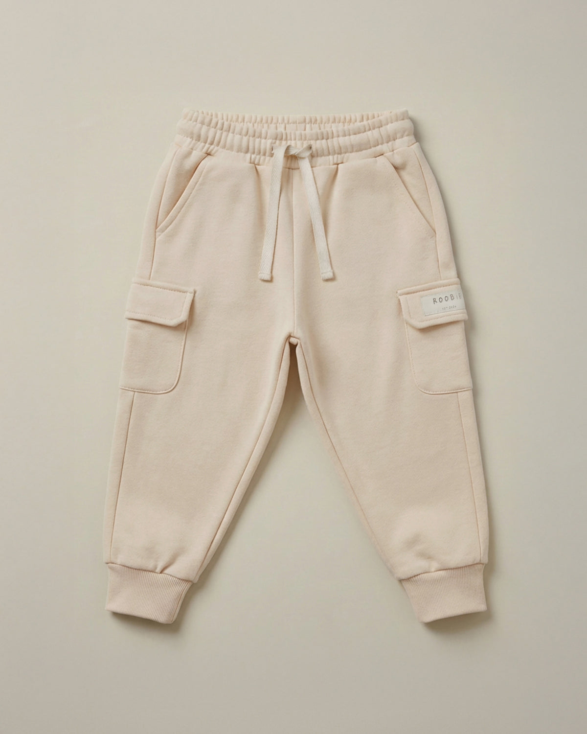 ROOBiE cargo trousers in cream, with cargo pockets, oversized fit and elasticated waist.