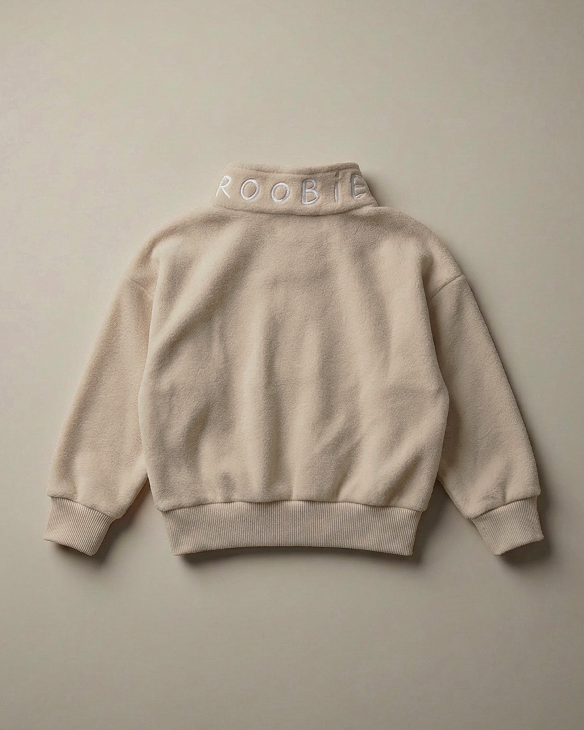 A neutral ROOBiE oversized quarter-zip sweatshirt showing the quarter-zip neckline and oversized fit in a clean product image.