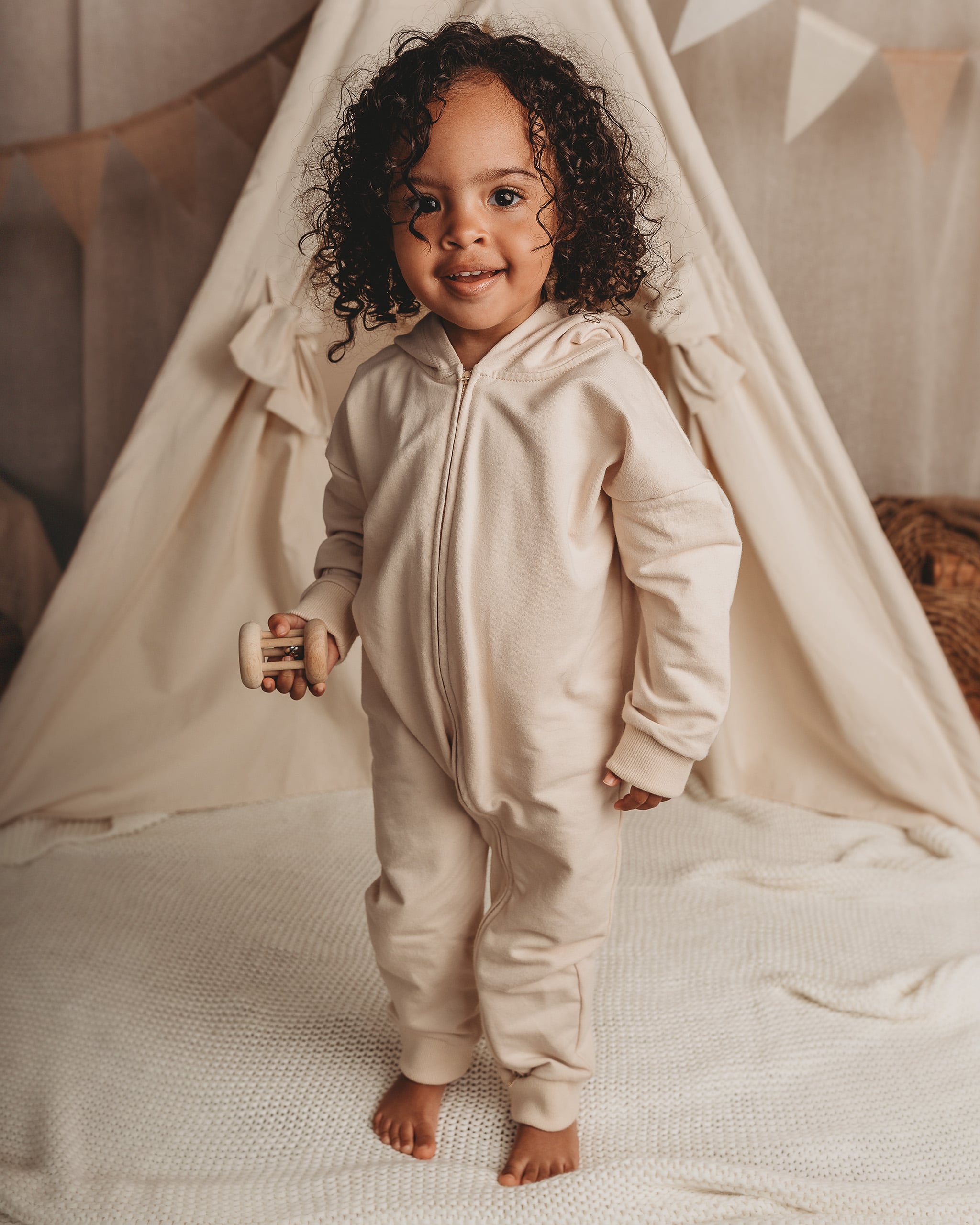 ROOBiE toddler jumpsuit in MACADAMiA MiLK – neutral beige hooded one-piece, designed for a capsule wardrobe