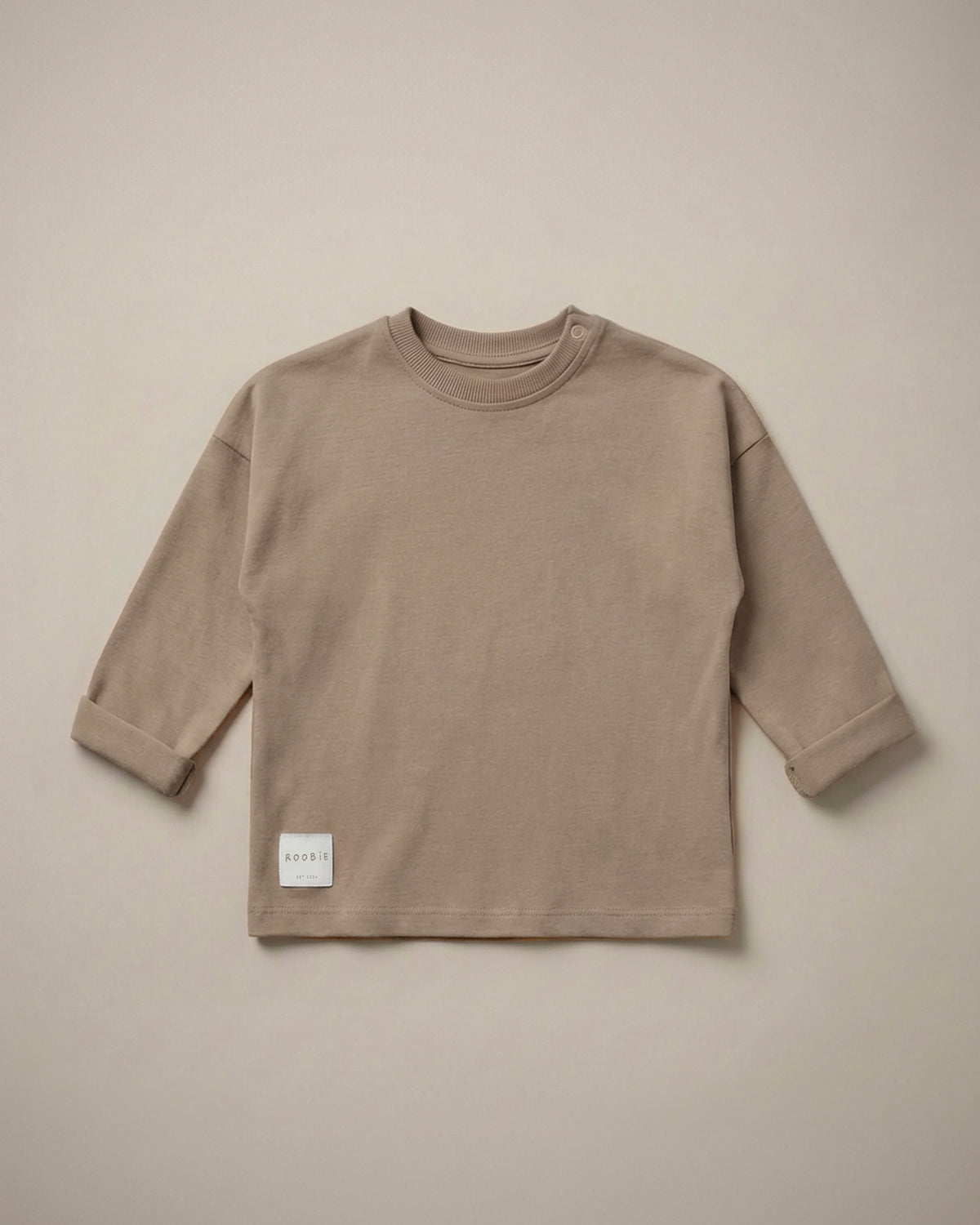 A warm brown oversized long sleeve t-shirt from ROOBiE, featuring an oversized fit, photographed against a neutral background.