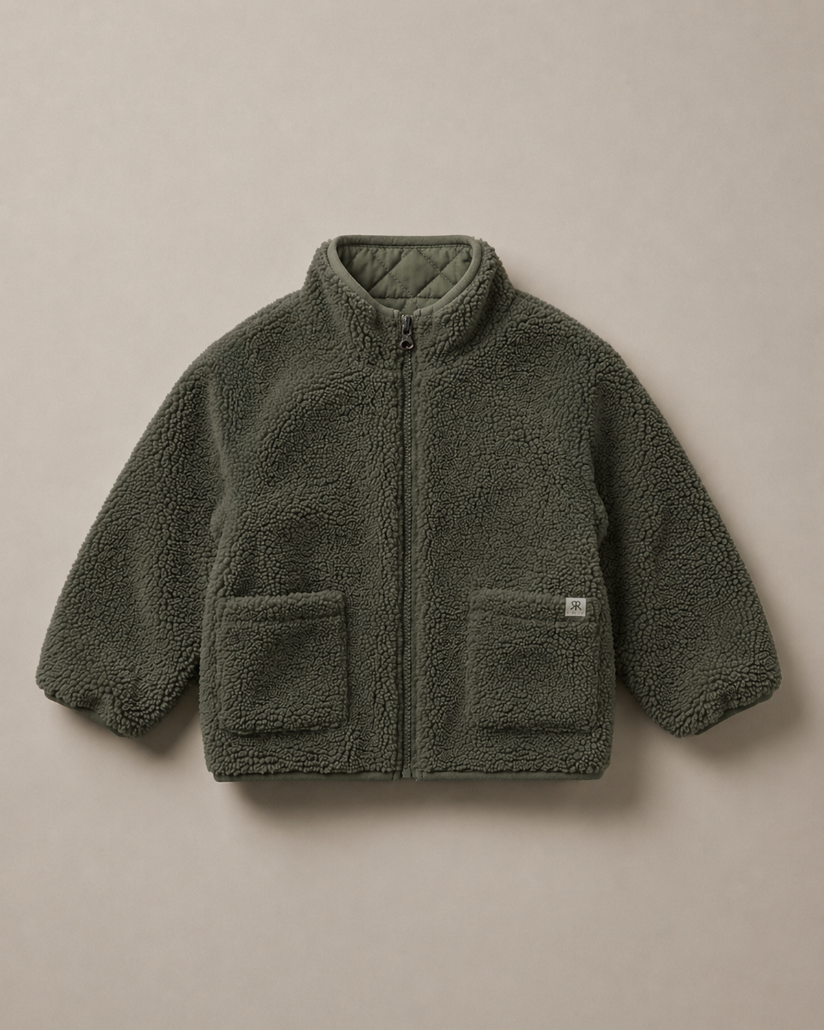 A sage green teddy fleece zip-up jacket with a quilted stand collar and two front patch pockets, laid flat against a neutral beige background.