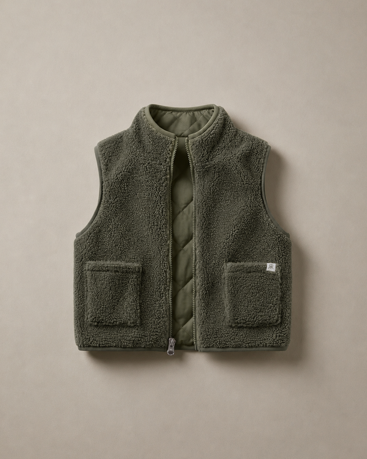 A sage olive teddy fleece gilet with a quilted inner and two front patch pockets, displayed flat against a neutral taupe background.