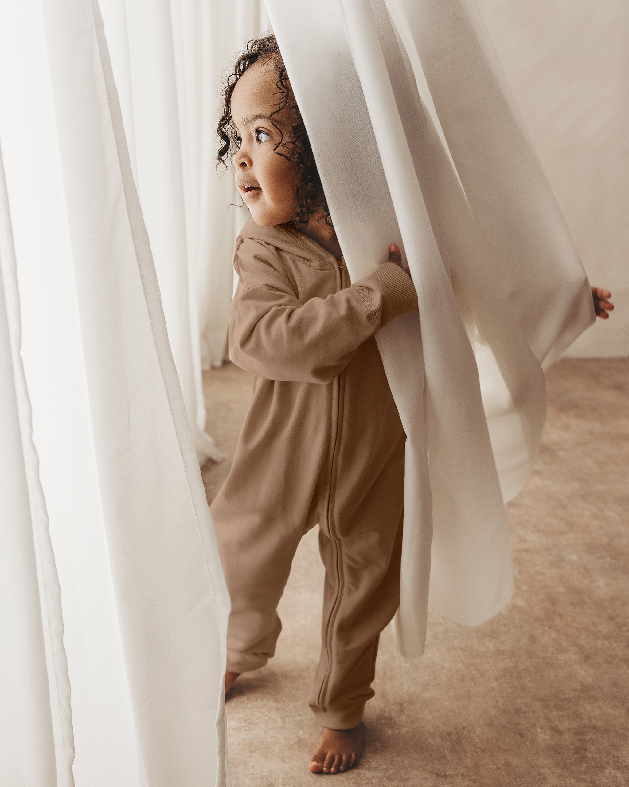 ROOBiE toddler jumpsuit in CHOCCY BiCCY – rich brown hooded one-piece, capsule wardrobe staple for toddlers