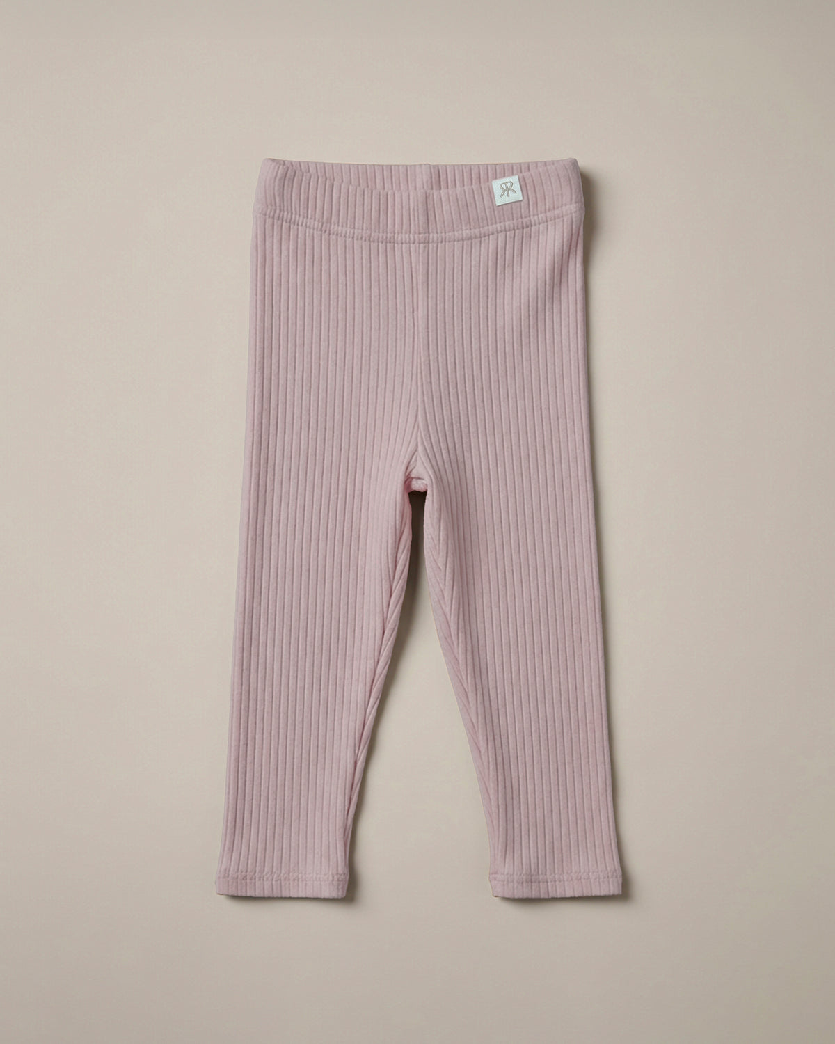 A soft pink ribbed leggings from ROOBiE, featuring ribbed fabric and stretch fit, photographed against a neutral background.