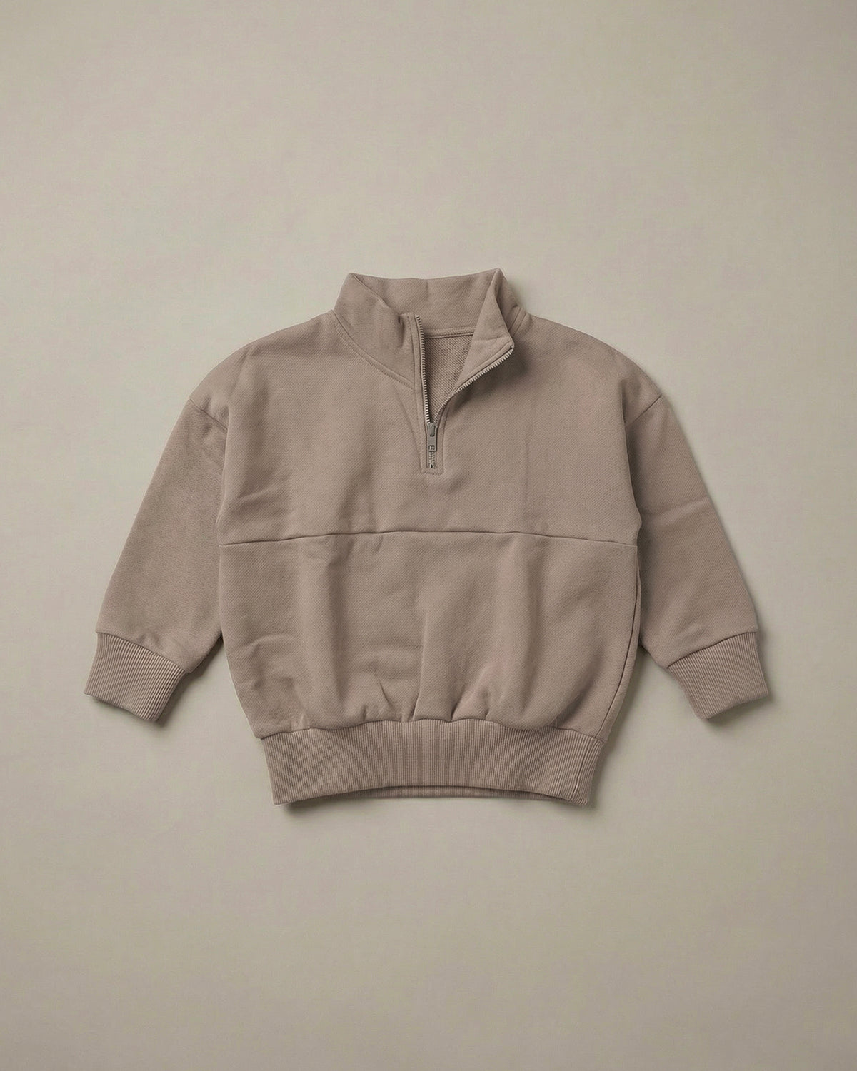 ROOBiE warm brown quarter-zip sweatshirt, featuring quarter-zip neckline with oversized fit and long sleeves on a neutral background.