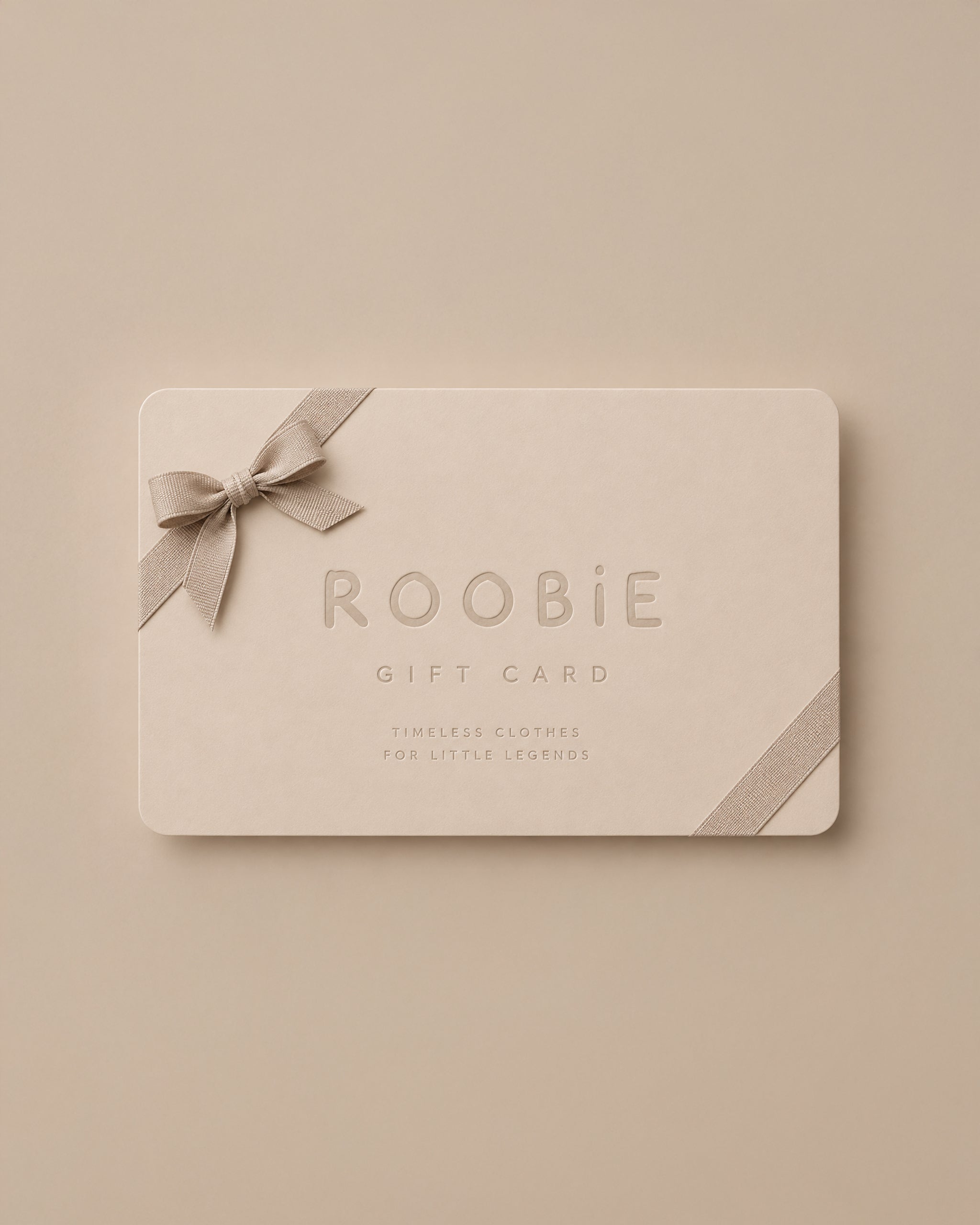 A rectangle ROOBIE gift card in a neutral cream tone, decorated with a matching ribbon bow and diagonal ribbon accent, shown on a matching beige background.
