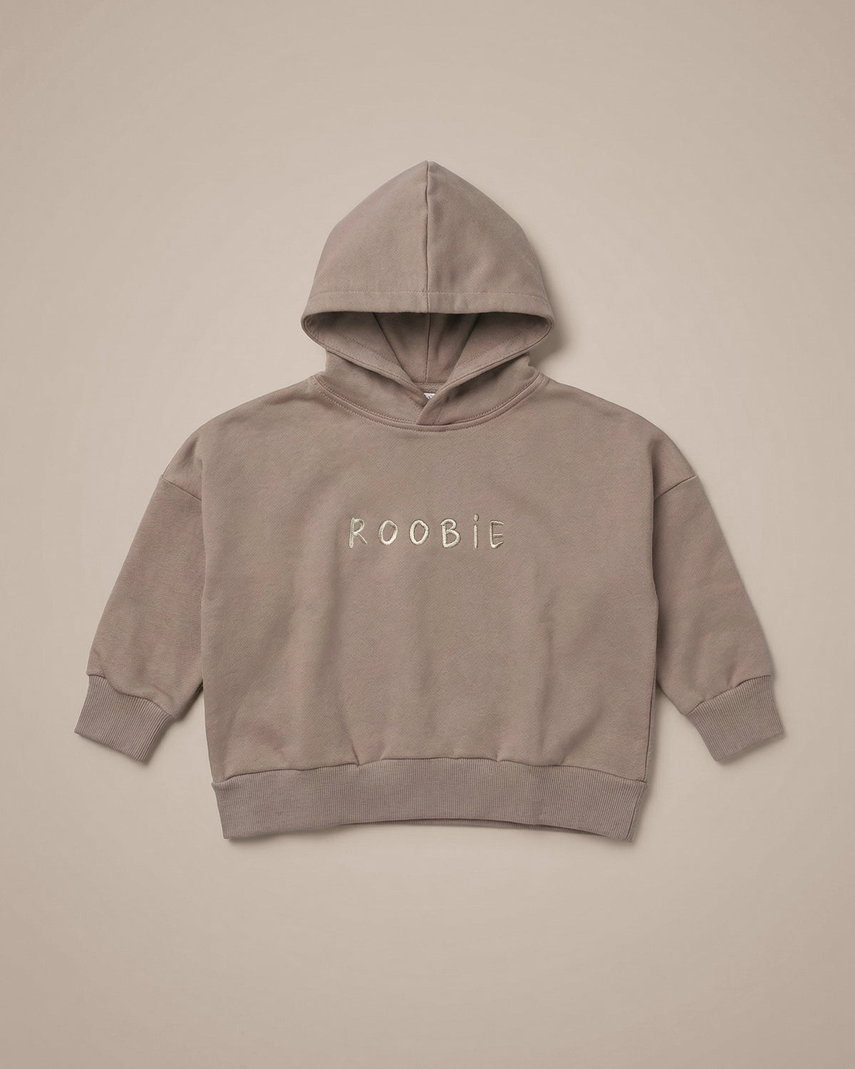 A warm brown hoodie from ROOBiE, featuring oversized fit and hooded neckline, photographed against a neutral background.